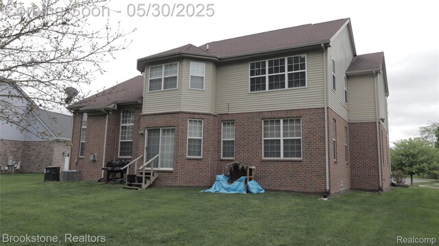 13961 Cobblestone Creek Dr, Belleville, MI 48111 - rear view of property with a lawn, entry steps, and brick siding