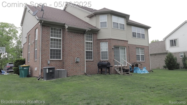 13961 Cobblestone Creek Dr, Belleville, MI 48111 - back of property featuring brick siding, a yard, entry steps, and central air condition unit