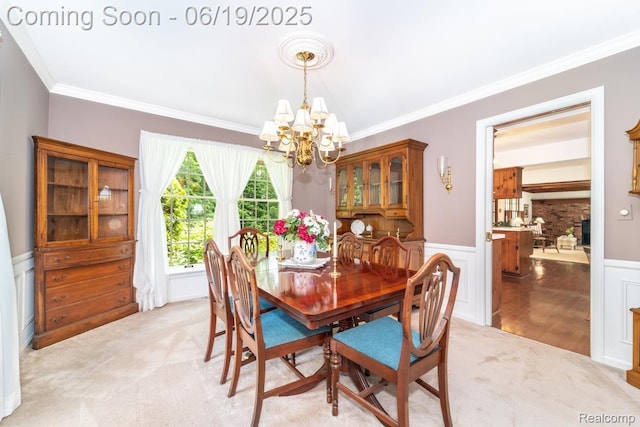 18410 Fermanagh Ct, Northville, MI 48168 - dining room featuring a chandelier, ornamental molding, wainscoting, and light colored carpet
