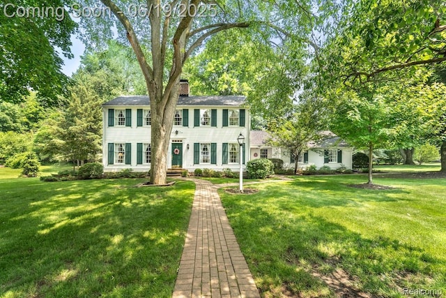 18410 Fermanagh Ct, Northville, MI 48168 - colonial home with a chimney and a front lawn