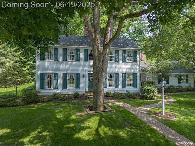 18410 Fermanagh Ct, Northville, MI 48168 - colonial house featuring a chimney and a front lawn