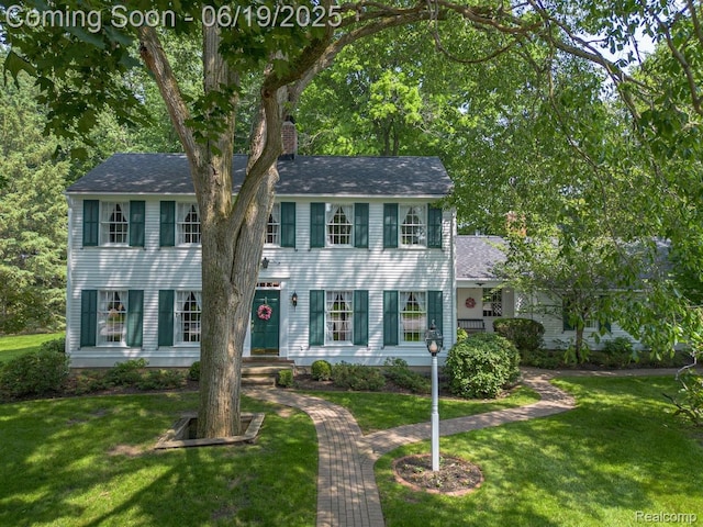 18410 Fermanagh Ct, Northville, MI 48168 - view of front of property with a chimney, a front lawn, and roof with shingles