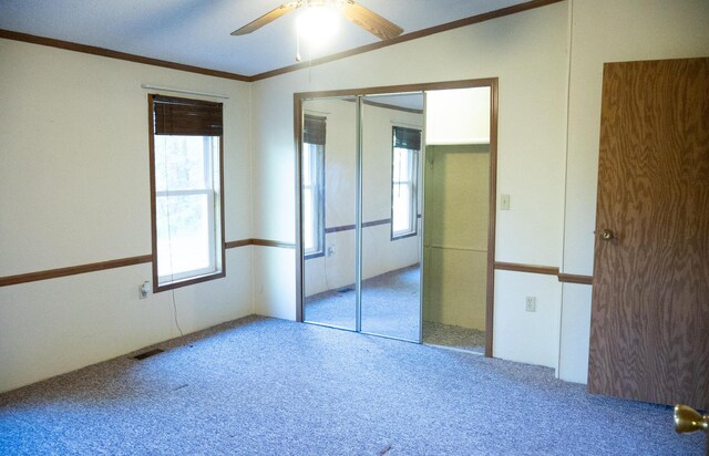 6340 Warren Woods Rd, Three Oaks, MI 49128 - unfurnished bedroom featuring carpet flooring, crown molding, a ceiling fan, and a closet