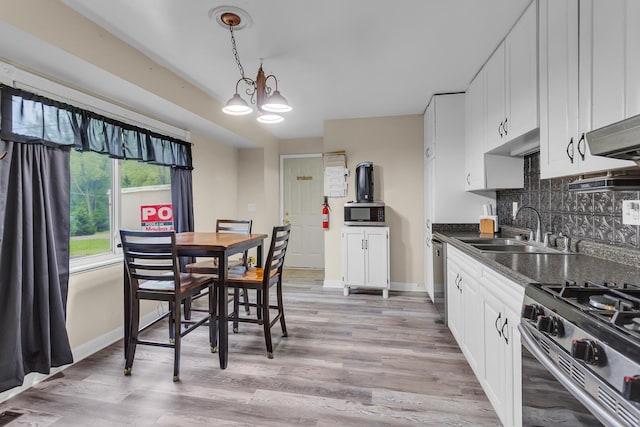 1094 Lake Marie Dr, Horton, MI 49246 - kitchen featuring a sink, dark countertops, backsplash, and baseboards