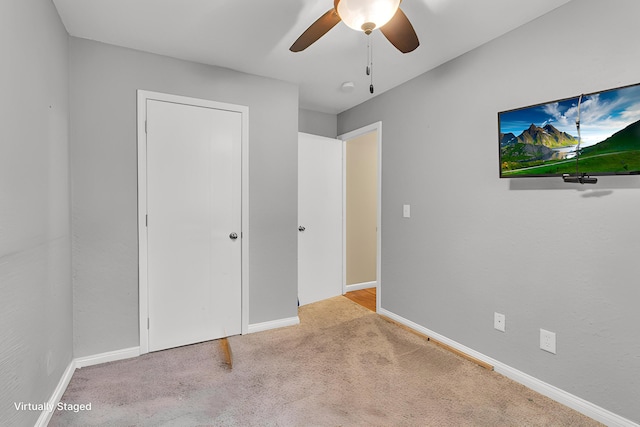 1094 Lake Marie Dr, Horton, MI 49246 - unfurnished bedroom with carpet floors, baseboards, and a ceiling fan