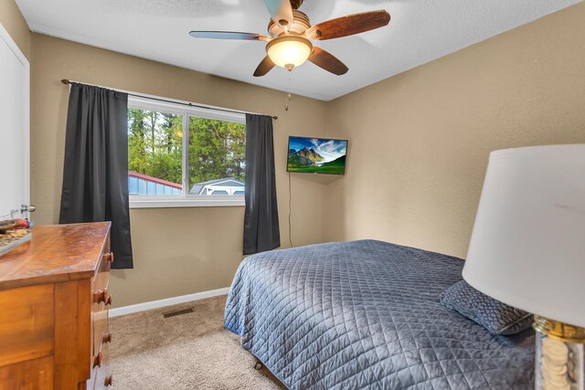 1094 Lake Marie Dr, Horton, MI 49246 - carpeted bedroom featuring baseboards and a ceiling fan