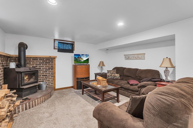 1094 Lake Marie Dr, Horton, MI 49246 - living area featuring carpet floors, a wood stove, recessed lighting, and baseboards