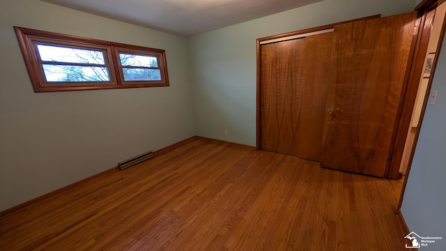 8263 Westwood St, Ida, MI 48140 - unfurnished bedroom featuring wood finished floors, baseboards, and a closet