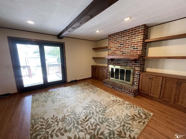 8263 Westwood St, Ida, MI 48140 - unfurnished living room featuring wood finished floors, a brick fireplace, baseboards, recessed lighting, and beamed ceiling