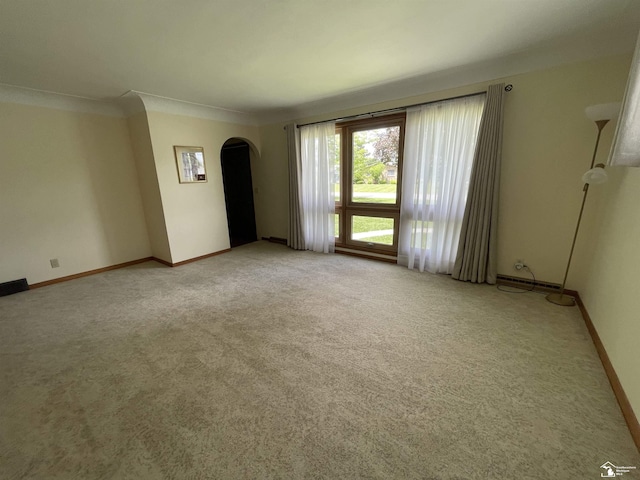 8263 Westwood St, Ida, MI 48140 - spare room with arched walkways, light colored carpet, baseboards, and ornamental molding