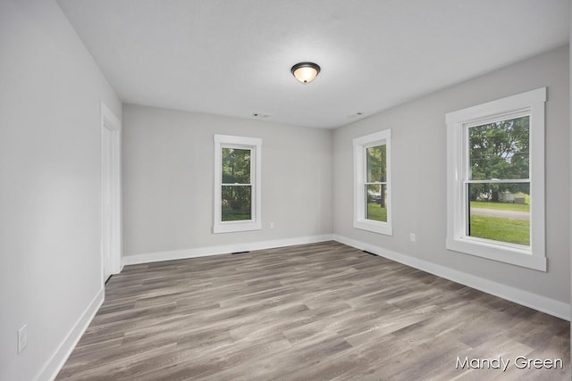 536 E Grant St, Sheridan, MI 48884 - empty room featuring wood finished floors and baseboards