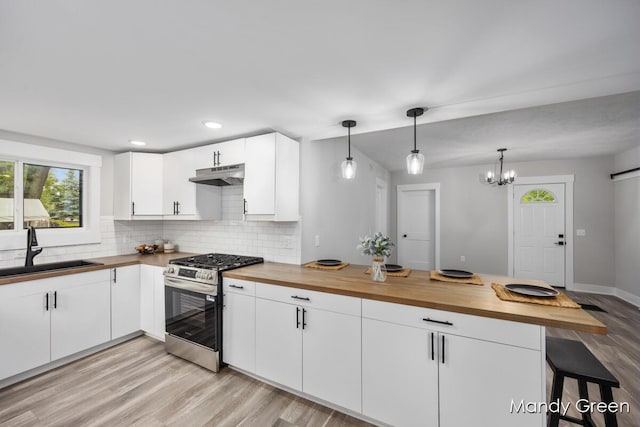 536 E Grant St, Sheridan, MI 48884 - kitchen featuring gas range, a sink, butcher block countertops, under cabinet range hood, and healthy amount of natural light
