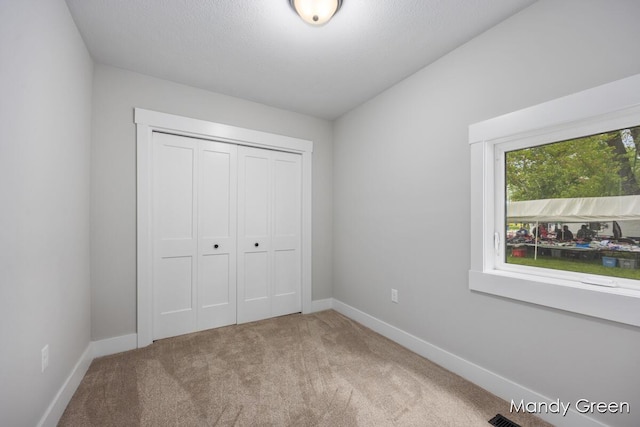 536 E Grant St, Sheridan, MI 48884 - unfurnished bedroom with carpet, a closet, and baseboards