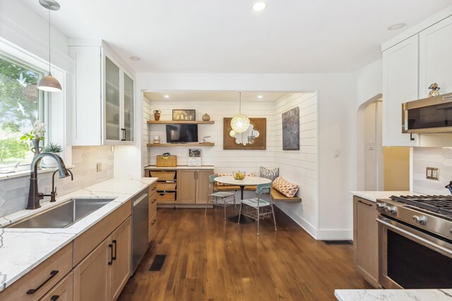 616 S Elm St, Three Oaks, MI 49128 - kitchen with a sink, appliances with stainless steel finishes, light stone counters, dark wood-style flooring, and decorative backsplash