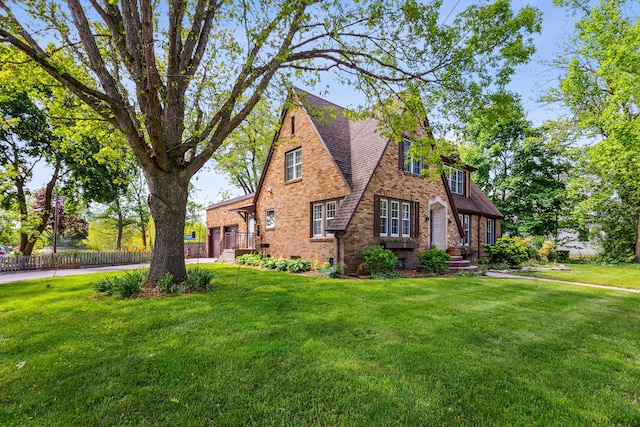 616 S Elm St, Three Oaks, MI 49128 - tudor-style house with a shingled roof and brick siding