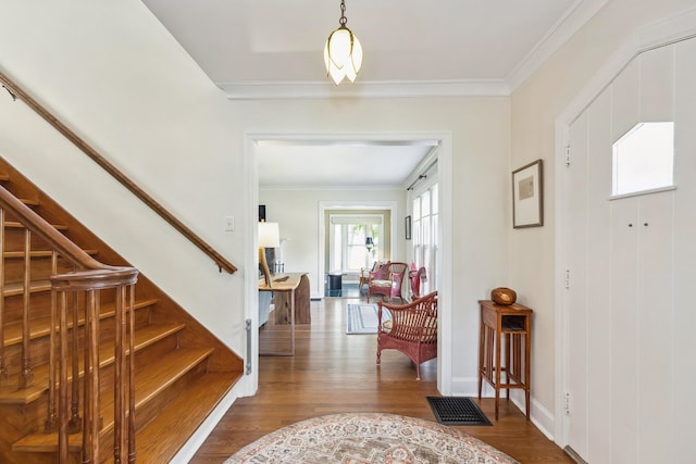 616 S Elm St, Three Oaks, MI 49128 - foyer entrance with wood finished floors, stairs, crown molding, and baseboards
