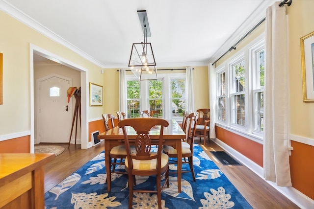 616 S Elm St, Three Oaks, MI 49128 - dining room featuring ornamental molding, wood finished floors, and baseboards