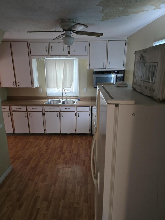 15495 Chelsea, Redford, MI 48239 - kitchen featuring a sink, dark wood finished floors, white cabinets, freestanding refrigerator, and a ceiling fan