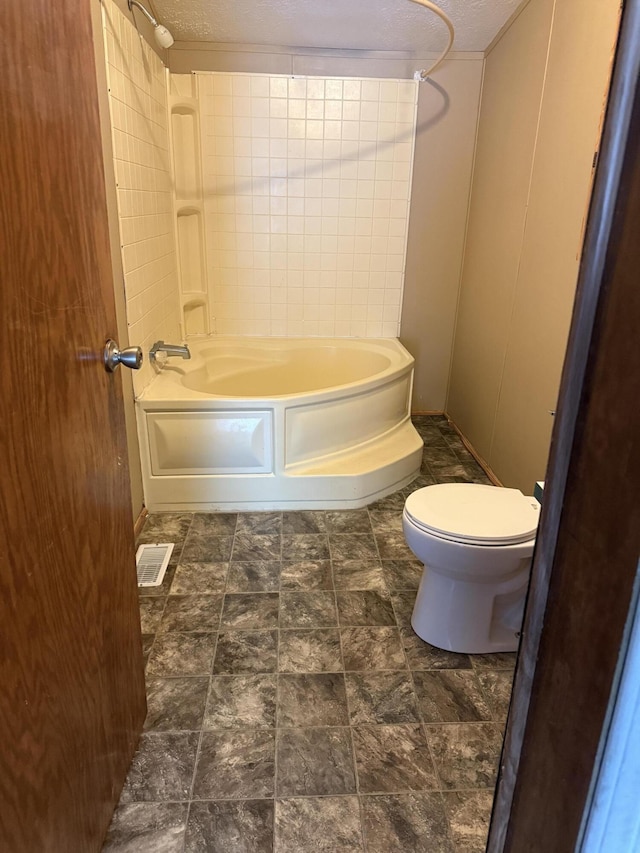 501 N US-131 Hwy # 17, White Pigeon, MI 49099 - bathroom featuring toilet, bathing tub / shower combination, and stone finish flooring