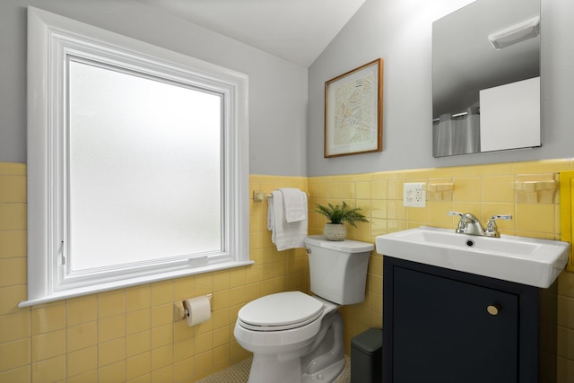 2316 Brockman Blvd, Ann Arbor, MI 48104 - bathroom with toilet, tile walls, vanity, lofted ceiling, and wainscoting