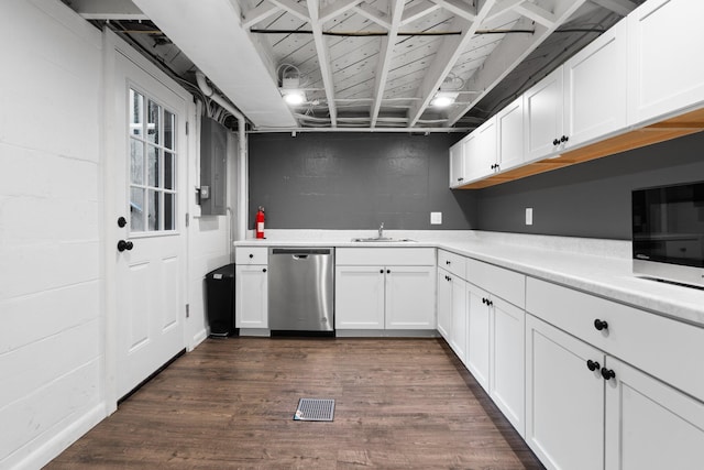 2316 Brockman Blvd, Ann Arbor, MI 48104 - kitchen featuring dishwasher, a sink, light countertops, concrete block wall, and white cabinetry