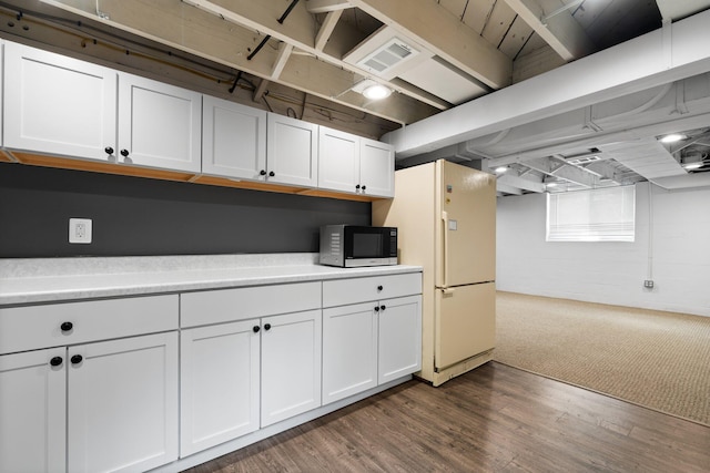 2316 Brockman Blvd, Ann Arbor, MI 48104 - kitchen with stainless steel microwave, freestanding refrigerator, white cabinets, light countertops, and dark wood-style flooring