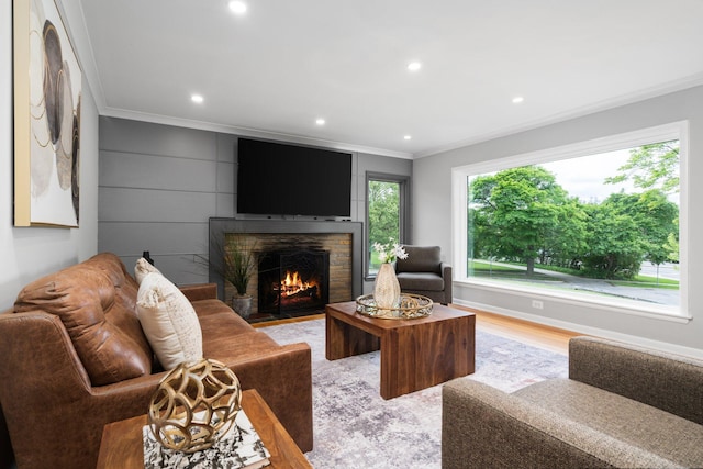 2316 Brockman Blvd, Ann Arbor, MI 48104 - living area with crown molding, a fireplace with flush hearth, recessed lighting, and light wood-type flooring