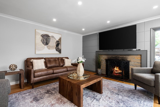 2316 Brockman Blvd, Ann Arbor, MI 48104 - living room featuring ornamental molding, a stone fireplace, recessed lighting, wood finished floors, and baseboards