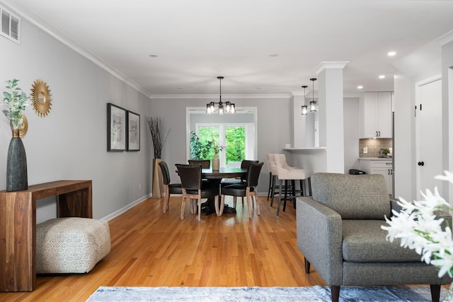 2316 Brockman Blvd, Ann Arbor, MI 48104 - dining area with baseboards, a chandelier, light wood finished floors, recessed lighting, and ornamental molding