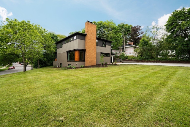 2316 Brockman Blvd, Ann Arbor, MI 48104 - view of home's exterior with a yard and a chimney