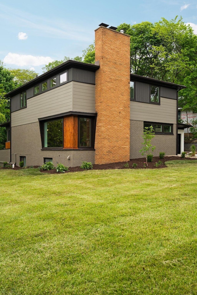 2316 Brockman Blvd, Ann Arbor, MI 48104 - view of side of home with a yard and a chimney