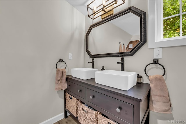 1104 James K Blvd, Pontiac, MI 48341 - bathroom with double vanity, wood finished floors, and baseboards