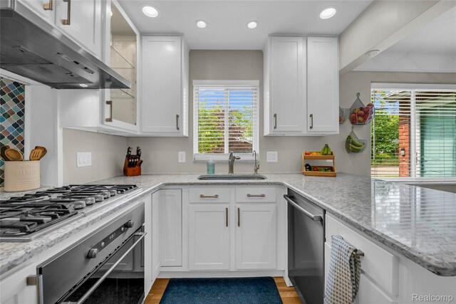 1104 James K Blvd, Pontiac, MI 48341 - kitchen with a sink, appliances with stainless steel finishes, under cabinet range hood, white cabinets, and recessed lighting