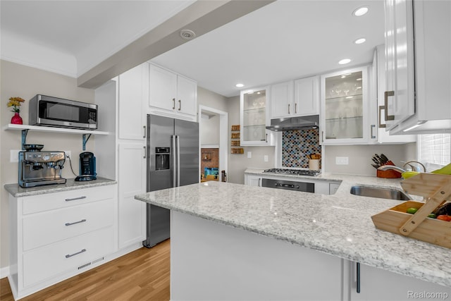 1104 James K Blvd, Pontiac, MI 48341 - kitchen featuring appliances with stainless steel finishes, a sink, under cabinet range hood, light wood-type flooring, and recessed lighting