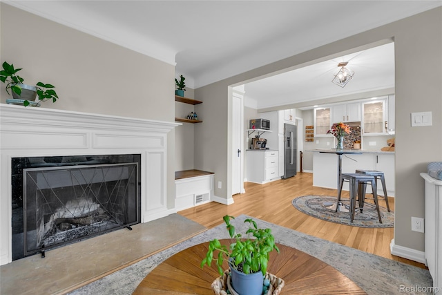 1104 James K Blvd, Pontiac, MI 48341 - living room with light wood-type flooring, a premium fireplace, and baseboards