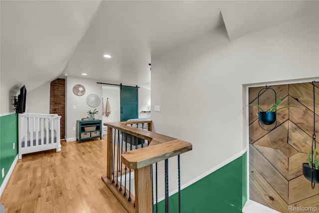 1104 James K Blvd, Pontiac, MI 48341 - hallway with light wood-style floors, a barn door, lofted ceiling, baseboards, and recessed lighting