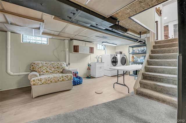 1104 James K Blvd, Pontiac, MI 48341 - basement with washing machine and dryer, healthy amount of natural light, stairs, and wood finished floors