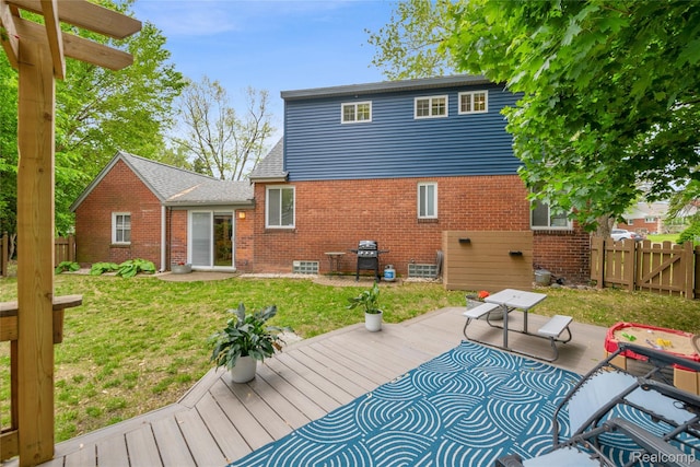 1104 James K Blvd, Pontiac, MI 48341 - back of property with brick siding and a wooden deck