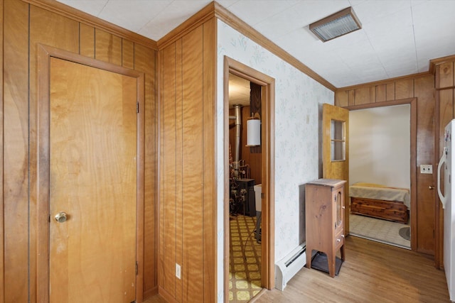 650 N Shore Dr, Crystal, MI 48818 - hall featuring baseboard heating, light wood-type flooring, crown molding, and wallpapered walls