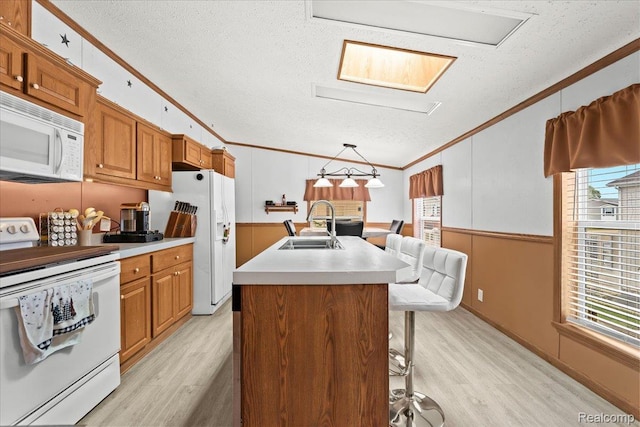 4813 Othello Ln, Northville, MI 48167 - kitchen featuring white appliances, crown molding, a sink, a textured ceiling, and light wood-style flooring
