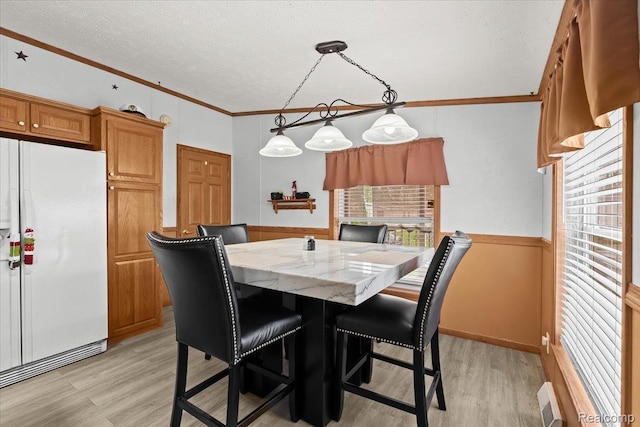 4813 Othello Ln, Northville, MI 48167 - dining space with light wood-style floors, crown molding, and a textured ceiling