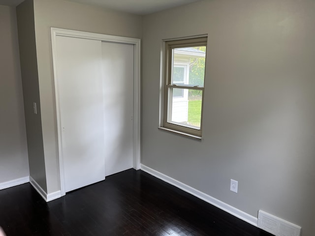 24680 Kenosha St, Oak Park, MI 48237 - unfurnished bedroom featuring baseboards, dark wood-style flooring, and a closet