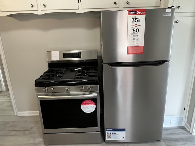 24680 Kenosha St, Oak Park, MI 48237 - kitchen featuring appliances with stainless steel finishes, white cabinets, and baseboards