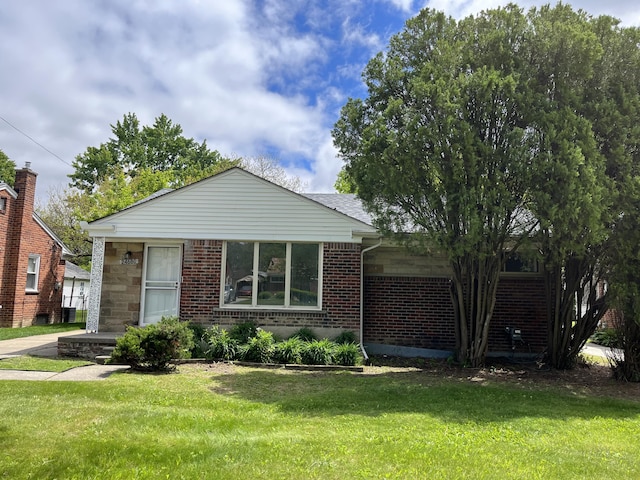 24680 Kenosha St, Oak Park, MI 48237 - view of front facade featuring brick siding and a front lawn