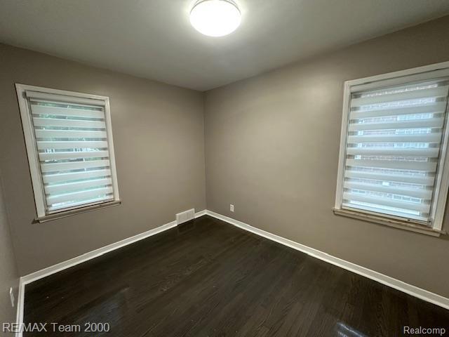 1042 Drexel St, Dearborn, MI 48128 - unfurnished room featuring dark wood-style flooring, baseboards, and plenty of natural light