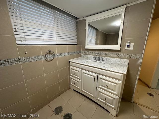 1042 Drexel St, Dearborn, MI 48128 - bathroom with tile walls, tile patterned flooring, and vanity