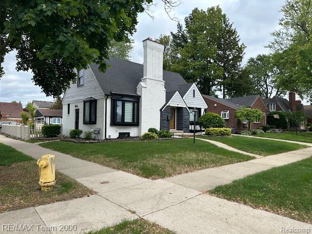 1042 Drexel St, Dearborn, MI 48128 - view of front of property featuring a chimney and a front lawn