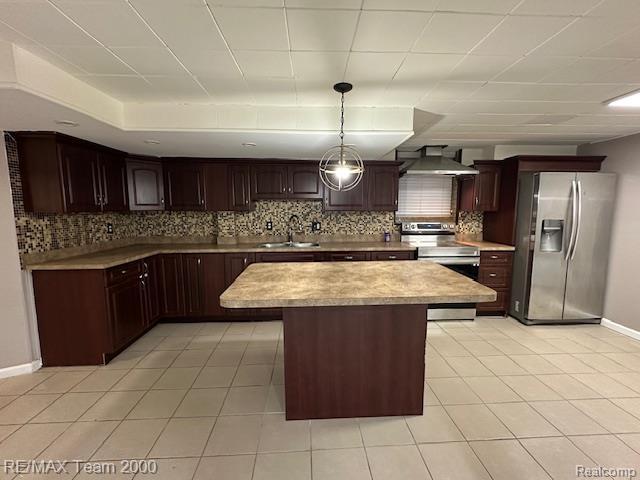 1042 Drexel St, Dearborn, MI 48128 - kitchen with appliances with stainless steel finishes, a sink, wall chimney range hood, decorative backsplash, and light countertops