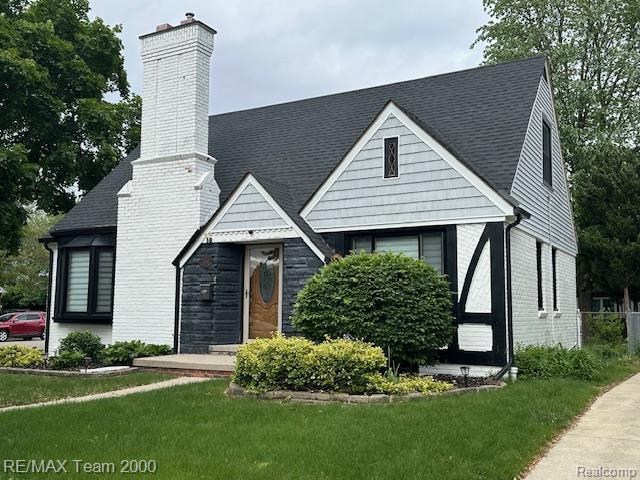1042 Drexel St, Dearborn, MI 48128 - english style home with a chimney, a front lawn, and brick siding