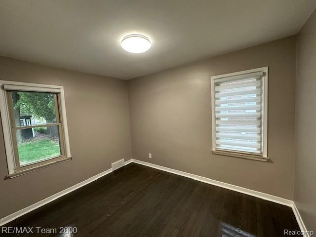 1042 Drexel St, Dearborn, MI 48128 - unfurnished room with dark wood finished floors and baseboards